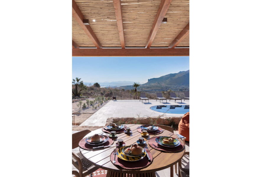 Beautiful outdoor dining setup at Villa Belvedere, a Sicily luxury villa with pool, overlooking the hills and coastline of Sicily.