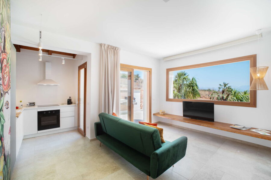 Modern living area at Villa Belvedere, a Sicily luxury villa with pool, featuring a stylish kitchen, cozy seating, and panoramic countryside views.