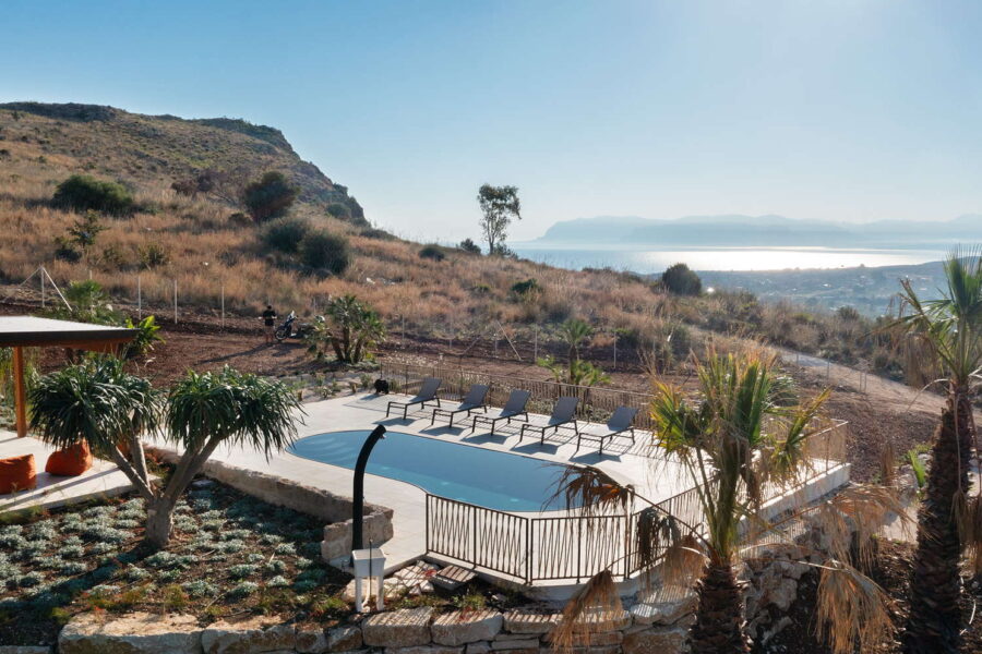 Stunning pool area at Villa Belvedere, a Sicily luxury villa with pool, offering panoramic views of the Mediterranean Sea and surrounding hills.