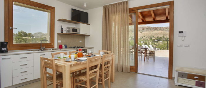 Bright Kitchen and Dining Area with Terrace Access at Villa Pietra Dorata – Sicily Luxury Villas