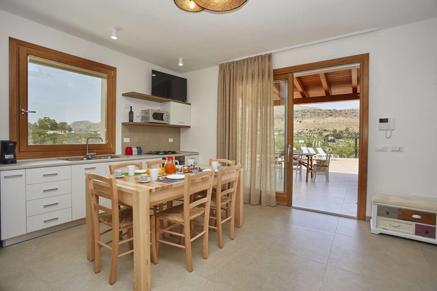 Bright Kitchen and Dining Area with Terrace Access at Villa Pietra Dorata – Sicily Luxury Villas