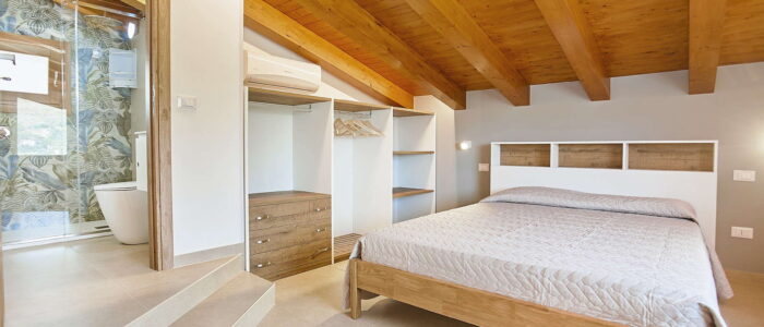 Elegant Bedroom with En-Suite and Wooden Beam Ceiling at Villa Pietra Dorata – Sicily Luxury Villas