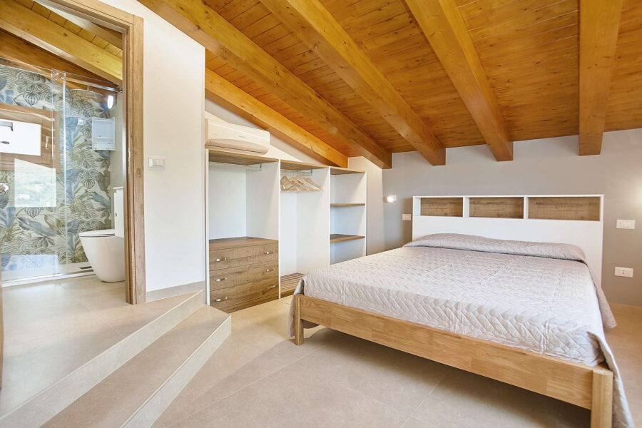 Elegant Bedroom with En-Suite and Wooden Beam Ceiling at Villa Pietra Dorata – Sicily Luxury Villas